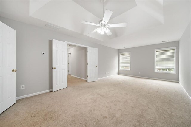 carpeted spare room with ceiling fan