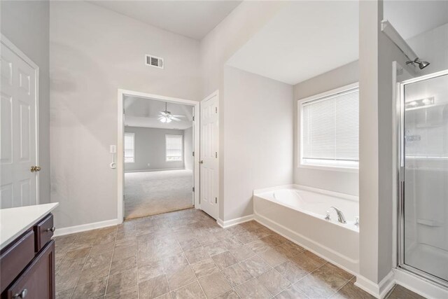 bathroom with ceiling fan, vanity, and independent shower and bath