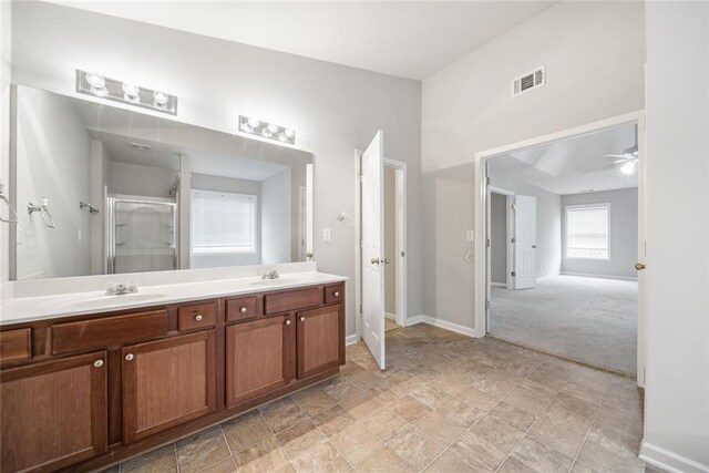 bathroom with ceiling fan, vanity, and an enclosed shower