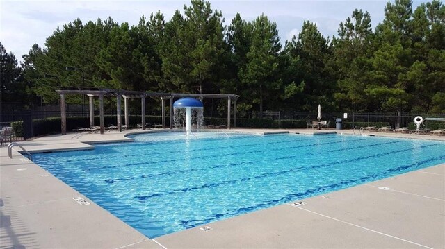 view of pool featuring pool water feature, a patio area, and a pergola