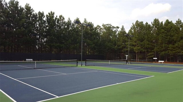 view of tennis court with basketball hoop