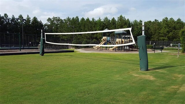 surrounding community featuring volleyball court and a lawn