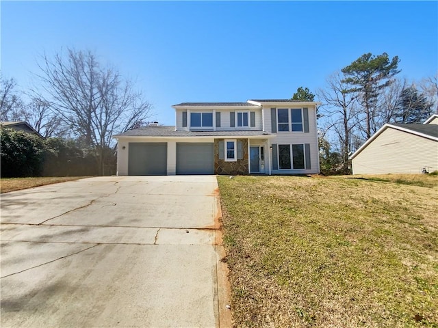 view of front of home with a garage, driveway, and a front yard