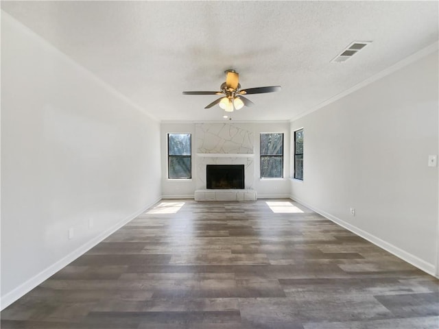 unfurnished living room featuring a fireplace, baseboards, and ornamental molding