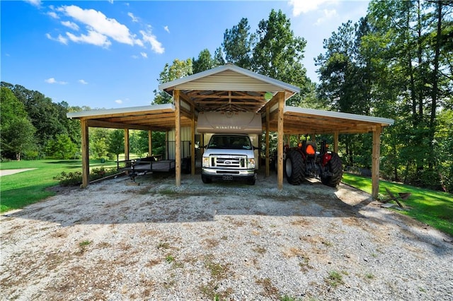 view of vehicle parking featuring a lawn and a carport