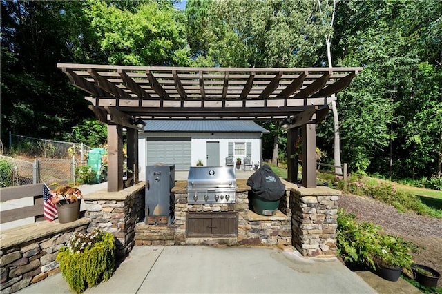 view of patio / terrace with a pergola, area for grilling, and exterior kitchen