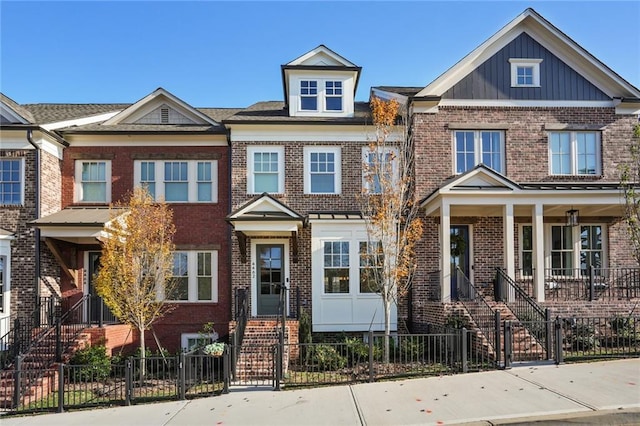 view of property featuring a fenced front yard and brick siding