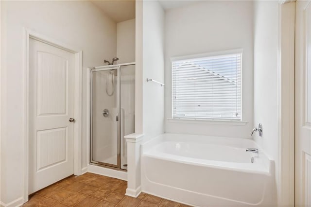 bathroom with tile patterned flooring, a garden tub, and a stall shower