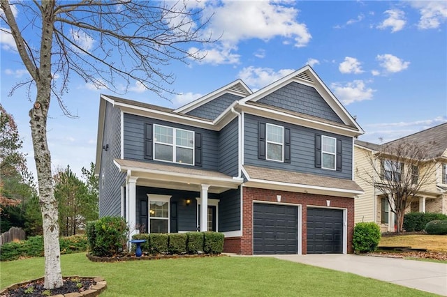 view of front of house featuring a garage, a front yard, concrete driveway, and brick siding