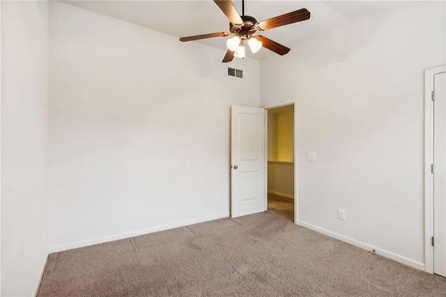 unfurnished bedroom with visible vents, ceiling fan, baseboards, carpet, and lofted ceiling