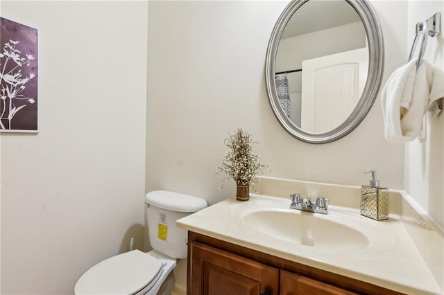 bathroom with toilet and vanity