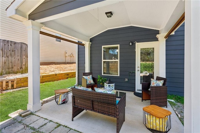 view of patio with a porch and fence