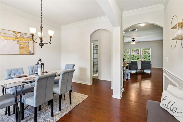 dining space with visible vents, baseboards, wood finished floors, and crown molding