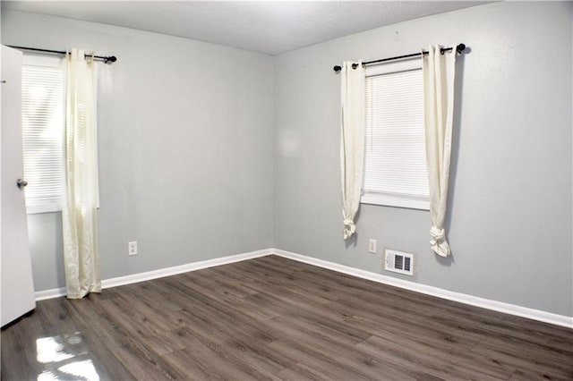 empty room with dark hardwood / wood-style floors