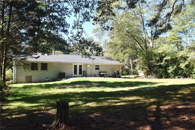 rear view of house featuring a yard