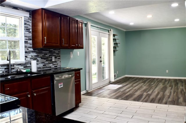 kitchen featuring plenty of natural light, stainless steel dishwasher, french doors, and light hardwood / wood-style flooring