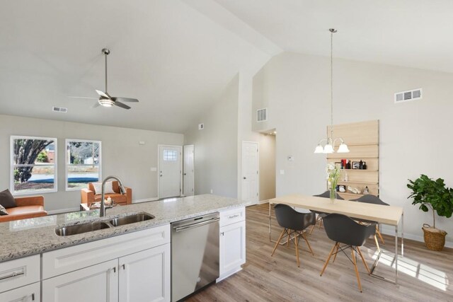 kitchen featuring visible vents, light wood-style floors, white cabinets, a sink, and dishwasher