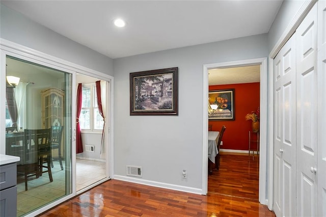 hall with dark hardwood / wood-style floors