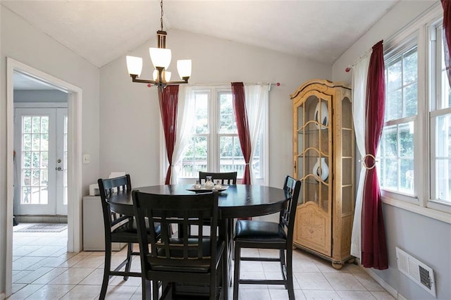 dining space featuring light tile patterned flooring, lofted ceiling, and a wealth of natural light