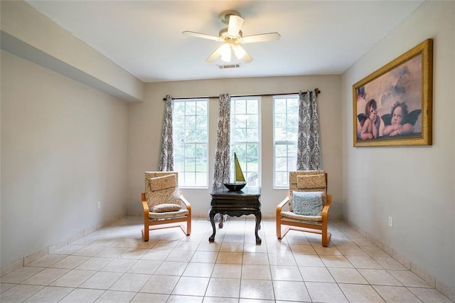 sitting room featuring light tile patterned floors and ceiling fan