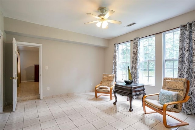 sitting room featuring light tile patterned flooring and ceiling fan