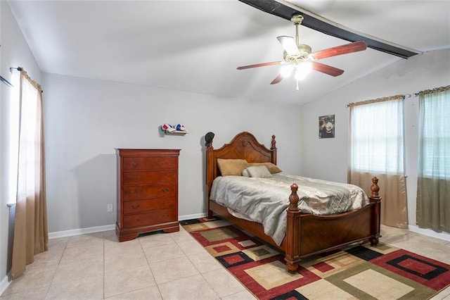 bedroom with ceiling fan, lofted ceiling with beams, multiple windows, and light tile patterned floors