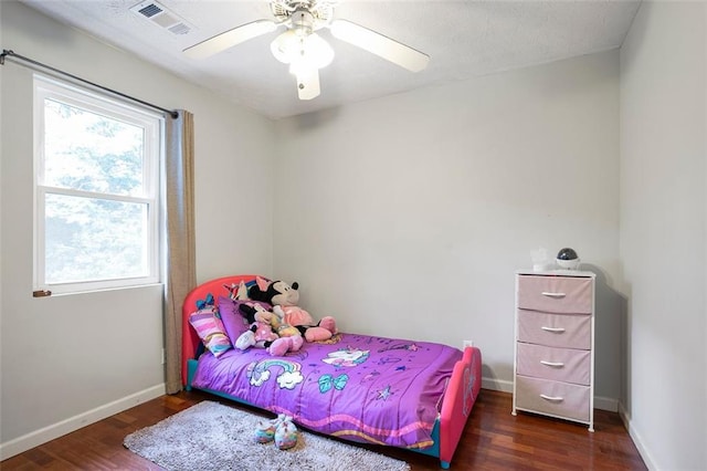 bedroom featuring dark hardwood / wood-style flooring and ceiling fan