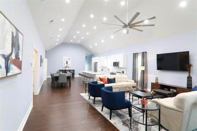 living room featuring high vaulted ceiling, ceiling fan, and dark wood-type flooring