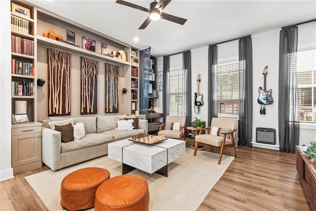 living area with light hardwood / wood-style flooring and ceiling fan