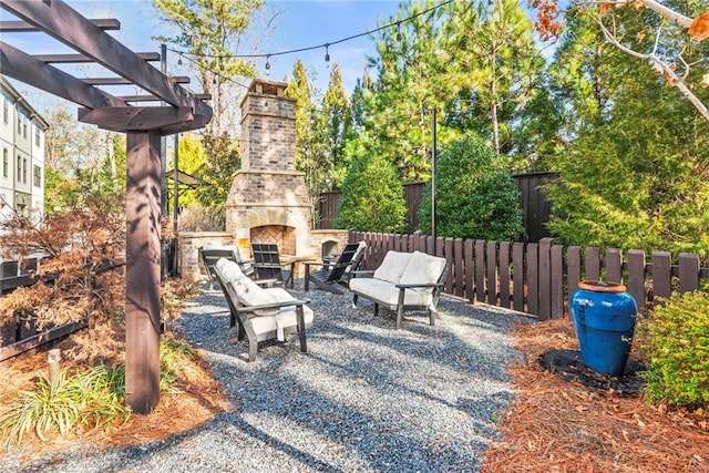 view of patio featuring an outdoor stone fireplace