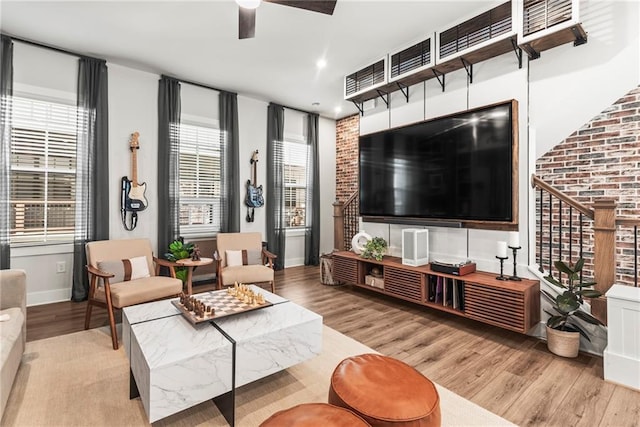 living room with ceiling fan and light wood-type flooring