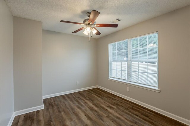 4045 Meadow Glen Way, Fairburn, GA 30213 - spare room featuring a ceiling fan, a textured ceiling, baseboards, visible vents, and dark wood-type flooring