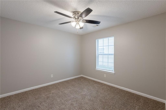 carpeted spare room with baseboards, a ceiling fan, and a textured ceiling