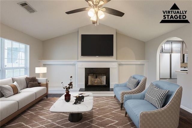 4045 Meadow Glen Way, Fairburn, GA 30213 - living room with wood finished floors, visible vents, lofted ceiling, ceiling fan, and a fireplace with raised hearth