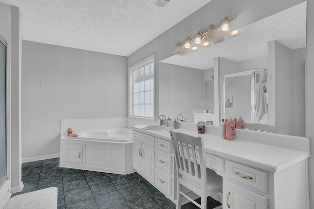 full bathroom featuring vanity, a bath, tile patterned flooring, a textured ceiling, and a shower with door