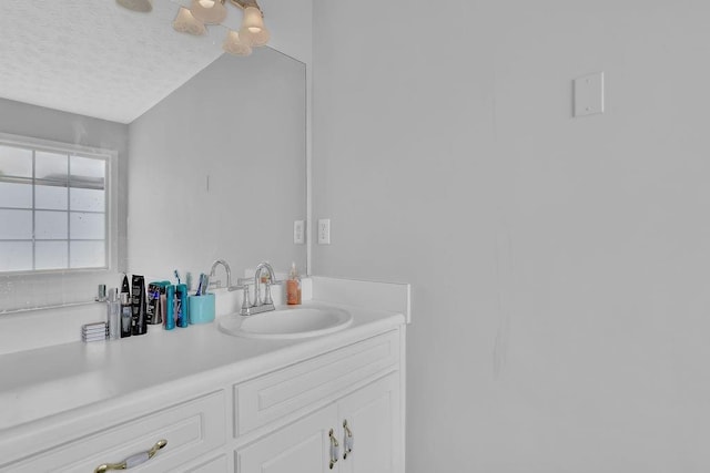 bathroom featuring a textured ceiling and vanity