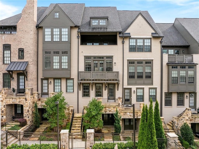 view of front of house featuring stairs and fence