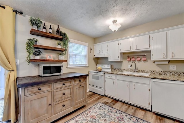 6700 Roswell Rd Unit 22B, Atlanta, GA 30328 - kitchen featuring white appliances, a sink, light wood-type flooring, open shelves, and white cabinetry