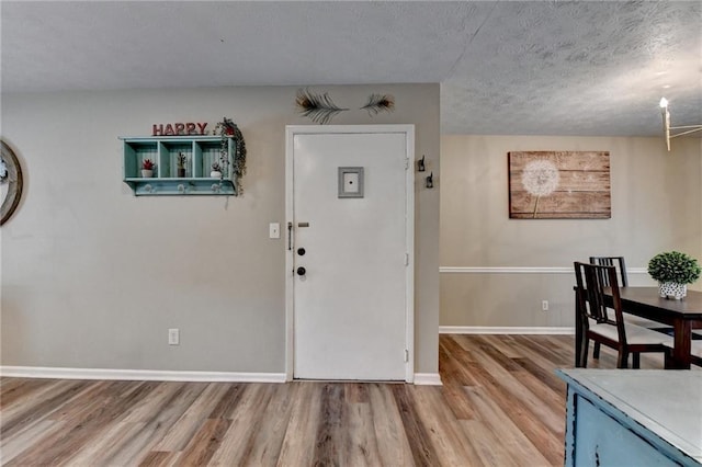 6700 Roswell Rd Unit 22B, Atlanta, GA 30328 - entryway featuring light wood-style flooring, a textured ceiling, and baseboards