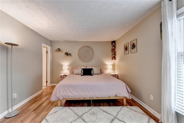 6700 Roswell Rd Unit 22B, Atlanta, GA 30328 - bedroom with multiple windows, wood finished floors, and baseboards