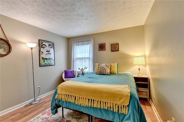 6700 Roswell Rd Unit 22B, Atlanta, GA 30328 - bedroom with light wood-type flooring, baseboards, and a textured ceiling