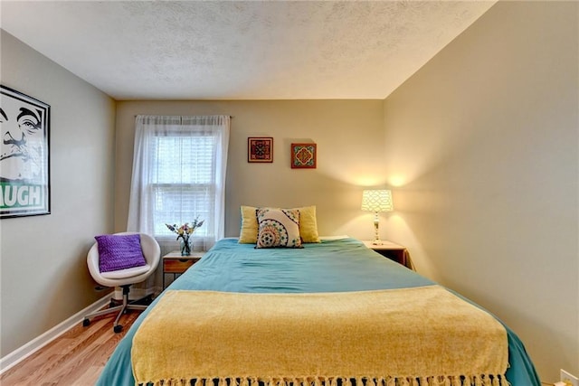 6700 Roswell Rd Unit 22B, Atlanta, GA 30328 - bedroom with wood finished floors, baseboards, and a textured ceiling