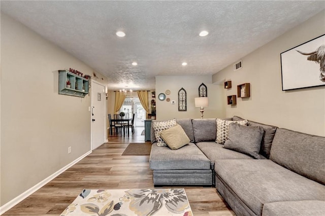 6700 Roswell Rd Unit 22B, Atlanta, GA 30328 - living area with recessed lighting, light wood-type flooring, baseboards, and a textured ceiling