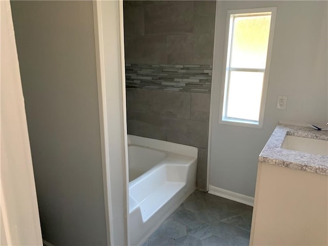 bathroom with a bathtub and vanity