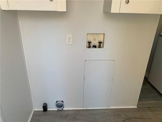 clothes washing area featuring dark hardwood / wood-style floors, cabinets, and hookup for a washing machine