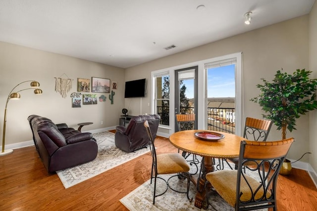 dining space with hardwood / wood-style flooring