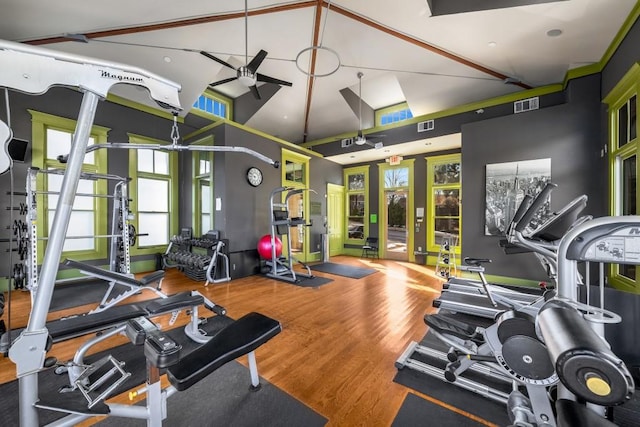 gym with high vaulted ceiling, ceiling fan, and wood-type flooring