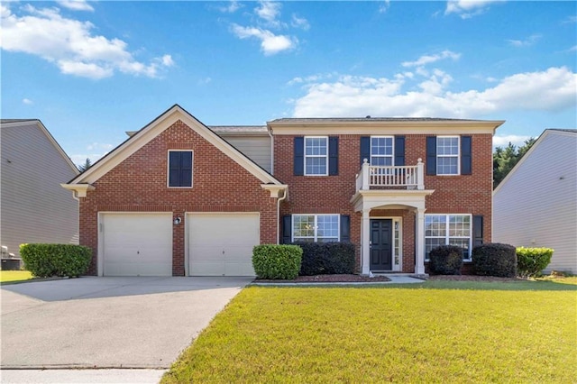 georgian-style home with brick siding, driveway, and a front yard