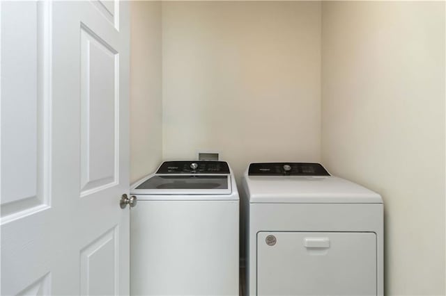 clothes washing area with separate washer and dryer