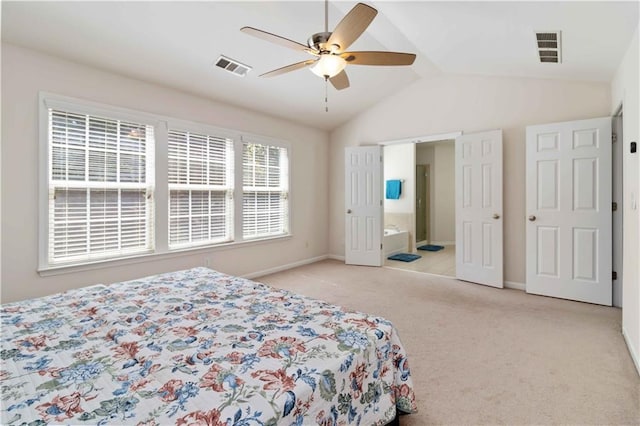 bedroom with carpet floors, vaulted ceiling, baseboards, ensuite bathroom, and a ceiling fan